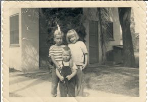 Eddie in overalls with older playmates, Richard and Jo Carol